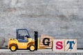 Yellow plastic forklift hold letter G to complete word GST & x28;Abbreviation of Goods and Services Tax& x29; Royalty Free Stock Photo