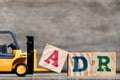 Yellow plastic forklift hold letter A to complete ADR Royalty Free Stock Photo