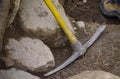 A plastic-handled pick leaning against a wall during work at an archaeological excavation Royalty Free Stock Photo