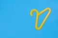 Yellow plastic hanger on a blue background Royalty Free Stock Photo