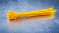 Yellow plastic self-locking cable ties on metallic background co Royalty Free Stock Photo