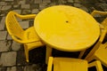 Yellow plastic table and chairs for outdoor relax.