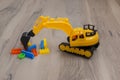 Yellow plastic toy. Toy tractor excavator. Child Game Royalty Free Stock Photo