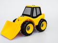 Yellow plastic tractor truck toy isolated white background