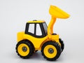 Yellow plastic tractor truck toy.
