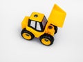 Yellow plastic tractor truck toy isolated white background