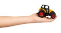 Yellow plastic traktor toy. Farming vehicle, harvest equipment