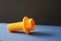 Yellow plastic bolt isolated on blue and black background