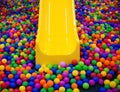 Yellow playground slide and plastic balls Royalty Free Stock Photo