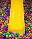 Yellow playground slide and plastic balls Royalty Free Stock Photo