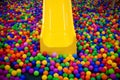 Yellow playground slide and plastic balls Royalty Free Stock Photo