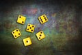 Yellow playing dice, with random numbers, on a green grunge poker table. Copy space. Gambling, poker, board games