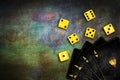 Yellow playing dice, with vintage playing cards, on a green grunge poker table. Copy space. Gambling, poker, board games