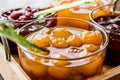 Yellow Plum jam in glass bowl with spoon and various marmalades Royalty Free Stock Photo