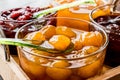 Yellow Plum jam in glass bowl with spoon and various marmalades Royalty Free Stock Photo