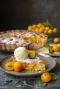 Yellow plum mirabelle. Plum cake with a scoop of vanilla ice cream on a dark background. Summer fruit season.harvest