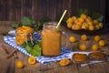 Yellow plum smoothie in glass, jam and ripe yellow plum on wooden table. Bio healthy food and drink Royalty Free Stock Photo