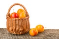 Yellow plums with leaf in a wicker basket on wooden table with white background Royalty Free Stock Photo