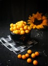 Yellow plums with sunflower on the black background. Ingredients for a jam. Food photography. Yellow sunflower, Royalty Free Stock Photo