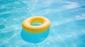 Yellow pool float, ring floating in a refreshing blue swimming pool Royalty Free Stock Photo