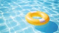 Yellow pool float, ring floating in a refreshing blue swimming pool Royalty Free Stock Photo