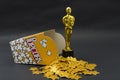 Yellow popcorn box with golden stars and plastic oscar award