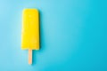 Yellow popsicle on blue