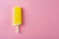 Yellow popsicle on pink background