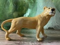 Yellow Porcelain Lioness Figurine On Green Glass Background