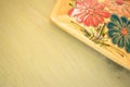 yellow porcelain tablemat on a pastel green background