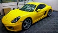 Yellow Porsche Cayman S inside workshop