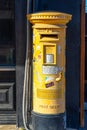Yellow post box in cylindrical shape in Cyprus.