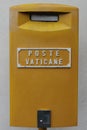 Yellow post box in Vatican City Rome Italy attached to the wall known as Poste Vaticane