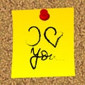 Yellow post with the message i love you caught on the cork board Royalty Free Stock Photo