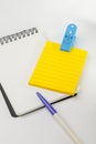 Yellow post note, empty white note, pen and blue clip Royalty Free Stock Photo