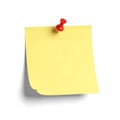 Yellow post-it note with red pushpin isolated on white background Royalty Free Stock Photo