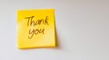 A yellow post-it note with the words thank you written on it Royalty Free Stock Photo