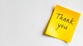A yellow post it note with the words thank you written on it Royalty Free Stock Photo