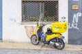 Yellow postal company motorcycle for parcel and letter delivery