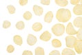 Yellow potato chips fly on white background, isolated, top view. Royalty Free Stock Photo