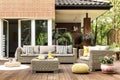 Yellow pouf on wooden patio Royalty Free Stock Photo