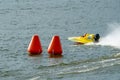 Yellow powerboat rounding a marker buoy in a race Royalty Free Stock Photo