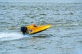 Yellow powerboat with number 26 go fast along the lake Royalty Free Stock Photo