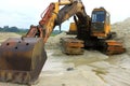 Yellow powerful excavator on a sandy quarry