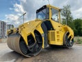 Yellow powerful large new modern road roller for asphalt paving and road repair at construction site. Construction machinery Royalty Free Stock Photo