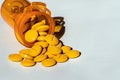 Yellow prescription pills spilled onto a table. Concept of opioid addiction and healthcare industry Royalty Free Stock Photo