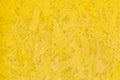 Yellow pressed wood texture, chipboard light surface background