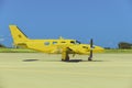 Yellow propeller plane parking at the airport Royalty Free Stock Photo