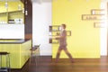 Yellow pub interior, shelves on wall, businessman Royalty Free Stock Photo