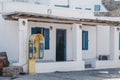 Yellow public telephone on a street in Hora Mykonos Town, Mykonos, Greece Royalty Free Stock Photo